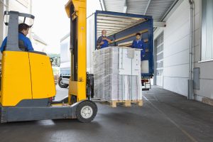 Factory worker operating forklift