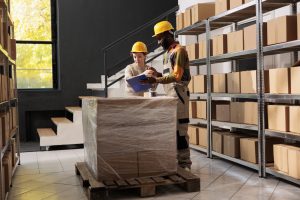 Employees preparing packages for delivery in storage room